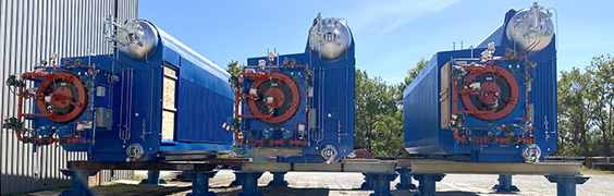 row of three package boilers on platforms