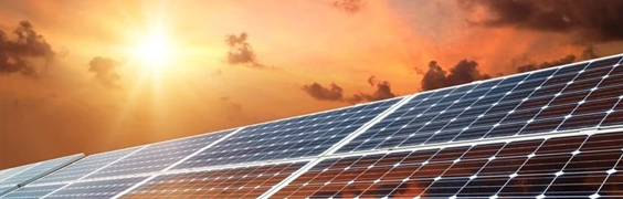solar panels with orange sky in background