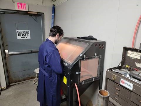 Glass bead blasting a tube sample