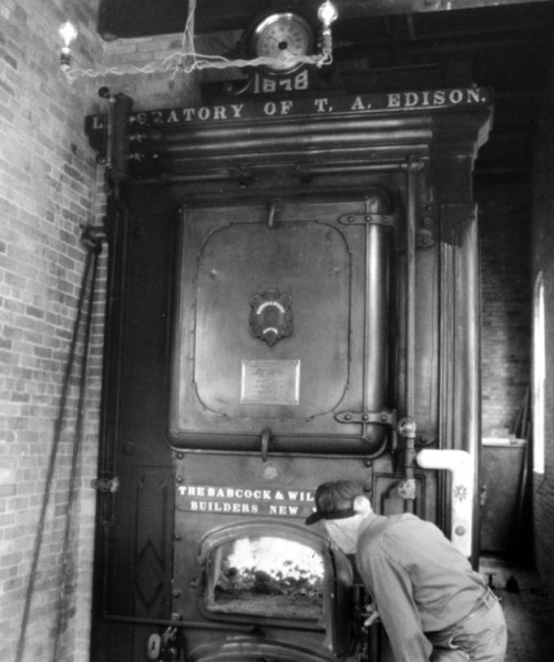Man peering into Babcock Wilcox Boiler from 1878 Thomas Edison Laboratory