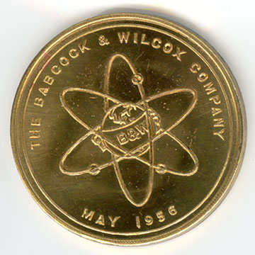 gold coin of Babcock Wilcox logo in nuclear rings from 1956