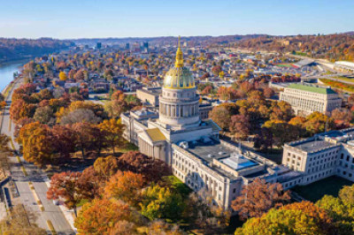 Aerial view of the West Virginia state capital building in the fall next to a river