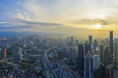 City skyline and sunrise with mountains in the distance