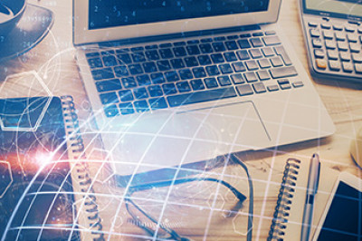 Computer, calculator and other office supplies and tools on a desk