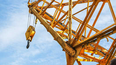 Large, elevated industrial crane extended toward the sky
