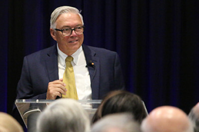 Man in a suit standing at a podium - Doug Lindsey BW Engineering Award Winner 2023 1