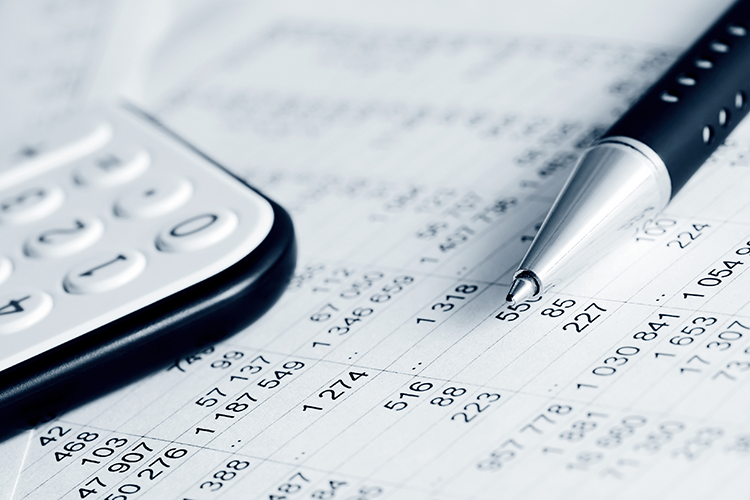 Pen and calculator resting on a paper