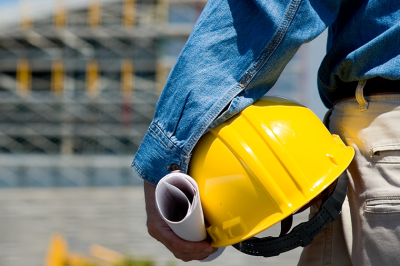 Person holding a hard hat under their arm