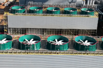 Two rows of four to five cooling towers at an industrial facility