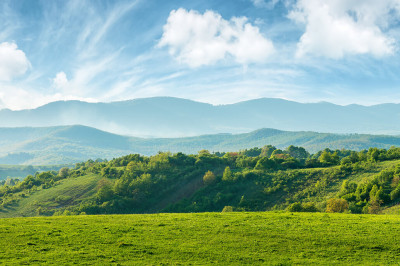 clouds sky mountains green hillside