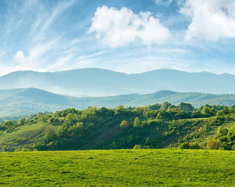 clouds sky mountains green hillside