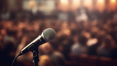 microphone on a stand in front of a blurred crowd