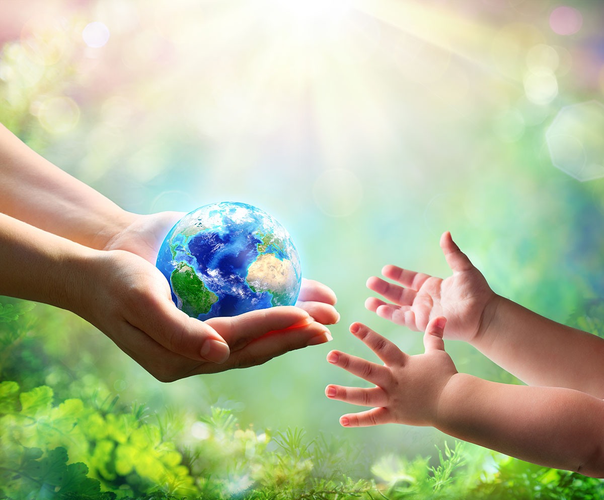 adult hands passing globe to toddler hands